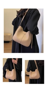 Detail view of beige pebbled leather tote bag showing textured finish and stitching
