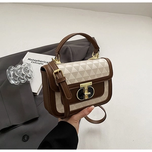 Detail of vintage patchwork crossbody bag with geometric fabric and golden T-lock