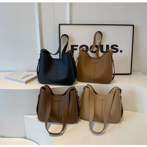 Litchi pattern leather buckets bags in four colors with wide shoulder straps detail