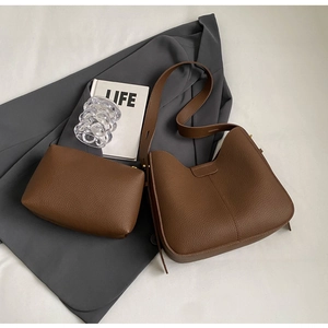 Close-up of brown lychee pattern leather tote bag with matching zipper pouch