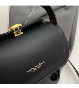 Close-up of premium black leather texture with gold metal buckle and embossed lettering