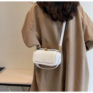 Detail of white leather crossbody square bag with gold buckle and fashion embossing