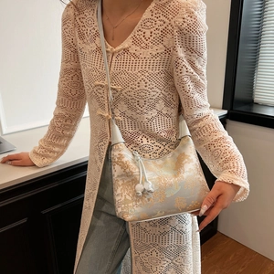 Blue hobo bag with gold jacquard landscape pattern and thin shoulder strap