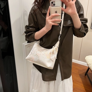 Elegant Chinese style floral print dumpling bag in cream with silk finish and tassel detail