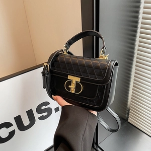 Chic black structured handbag with triangle quilting and gold metal turn-lock closure