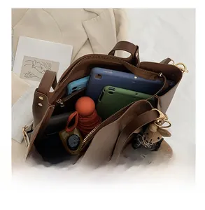 Interior view of large brown tote bag showing spacious capacity and inner zipper pocket