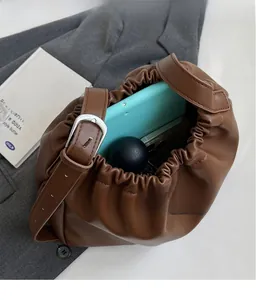 Detailed view of dark brown pleated bag interior showing large storage capacity
