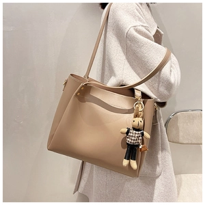 Large khaki tote bag with a chic houndstooth bunny charm detail on shoulder strap