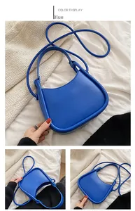 Detailed view of Klein Blue shoulder bag with smooth leather texture and curved contours