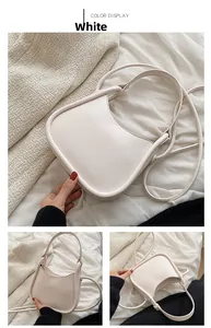 Detail of minimalist cream white hobo bag with smooth PU leather texture and sleek U-shape