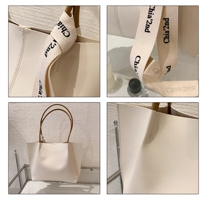 Close-up of beige tote bag with brown leather handles and Chia'2nd printed canvas detail