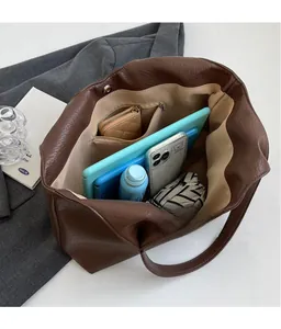 Spacious interior of brown lychee grain leather tote bag with pocket and daily items