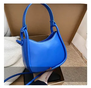 Detail view of Klein blue hobo bag showing smooth leather texture and adjustable strap
