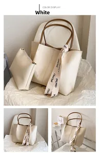 Detail view of cream tote bag set with brown handles and elegant printed ribbon accent