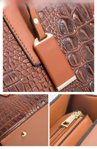 Détail macro du sac à main marron texture crocodile avec ferrures dorées de haute qualité
