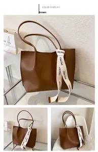 Detail view of large brown PU leather tote bag with stylish Chla'2nd ribbon decoration