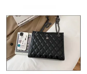 Size comparison of a black quilted chain bag with a tablet, showing its large capacity