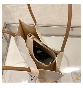 Top view of large white tote bag showing spacious interior with inner pouch and daily items