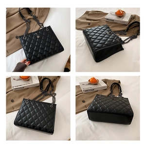 Detailed views of black quilted faux leather tote with silver chain and boxy structure