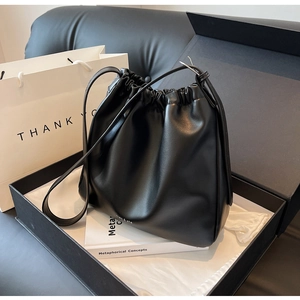 Black leather drawstring bag with logo detail in a premium gift box presentation