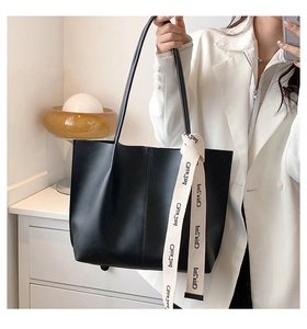 Detailed close-up of a large black tote bag featuring a branded Chris'sd woven strap
