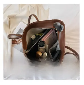Spacious interior of brown leather tote bag showing compartments for daily essentials
