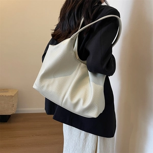 Minimalist off-white leather tote bag for women with a spacious casual shoulder design
