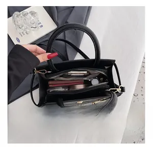 Top view of the spacious black faux-crocodile leather tote bag interior with a metal lock