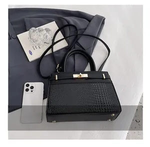 Detailed size comparison of the black crocodile pattern tote bag with a smartphone