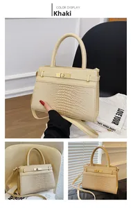 Detail view of khaki crossbody bag featuring faux crocodile texture and gold hardware