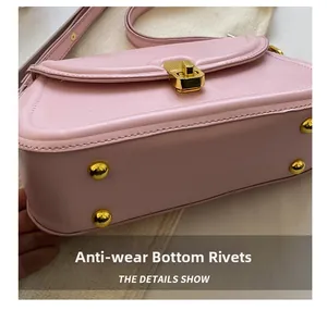 Detailed view of the pink shoulder bag featuring four protective gold metal bottom studs
