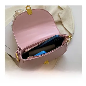 Interior view of pink saddle bag showing storage capacity for phone and wallet