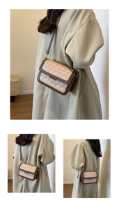 Detail of a brown and beige patchwork crossbody bag with geometric pattern and gold hardware