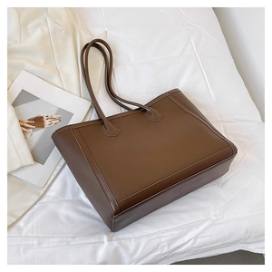 Detail shot of the deep brown large tote bag with high-quality lychee texture leather