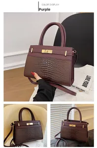 Detail of purple tote bag with crocodile texture, gold clasp and detachable strap