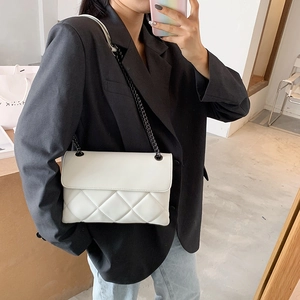 White quilted chain shoulder bag featuring elegant diamond lattice stitching and metal strap