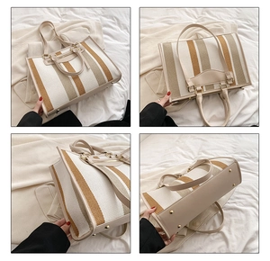 Detailoverzicht van grote canvas shopper met bruine strepen en metalen beschermnoppen