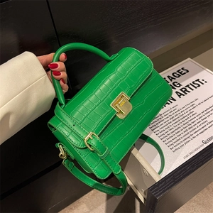 Glossy green crocodile texture handbag with gold twist lock and adjustable shoulder strap