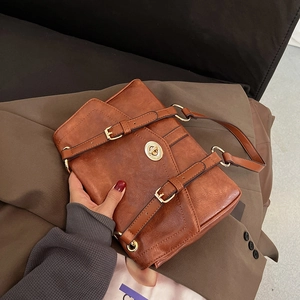 Classic brown vintage crossbody bag with gold metal twist lock and textured finish