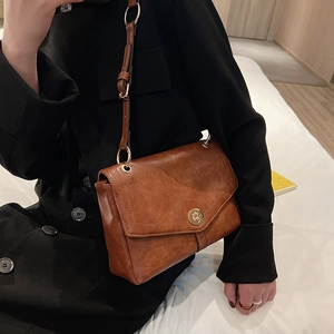 Chic retro caramel brown leather crossbody bag with elegant gold hardware for women