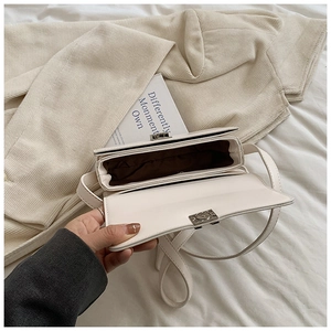 Top view of cream leather saddle bag showing dual interior compartments and hardware