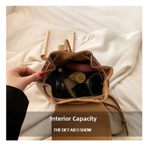 Top view of brown retro bucket bag showing spacious interior with cosmetics and umbrella