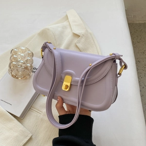 Detail of lavender PU leather shoulder bag with gold metal twist lock and smooth finish