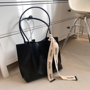 Large capacity black tote bag with unique round handles and woven side strap detail