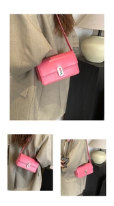 Macro view of bright pink saddle bag featuring a unique silver razor blade metal buckle