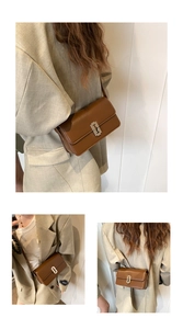 Detailed view of brown leather saddle bag with silver geometric buckle and shoulder strap