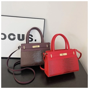 Detail of vintage crocodile pattern texture on deep wine red and bright red handbags