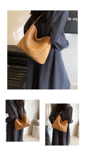 Detail of light brown PU leather shoulder bag with unique streamlined curved design