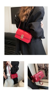 Detail of red leather shoulder bag with elegant silver rectangular metal buckle closure
