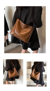 Detail of a brown leather tote bag with fine texture and golden stamped brand lettering